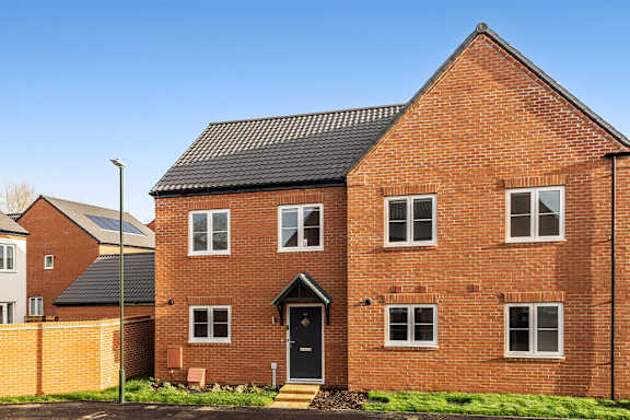 A red brick house with a black door and windows.
