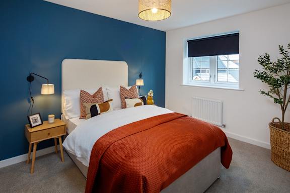 A bedroom with a large bed and a window.