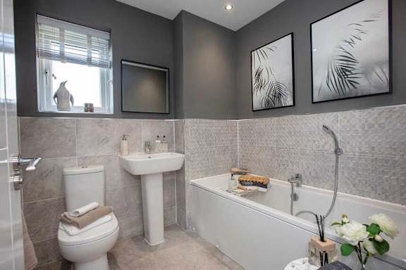 A bathroom with a white toilet, sink, and bathtub.