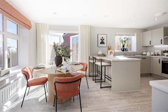 A modern kitchen with a dining table set for four.