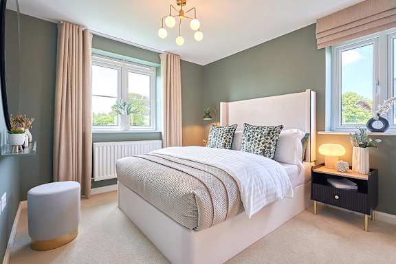 A bedroom with a large bed and a chandelier.