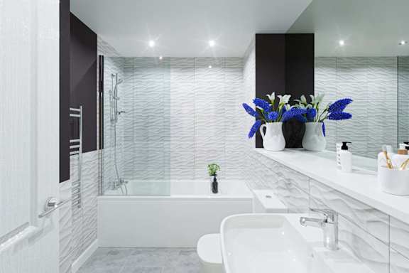 A white bathroom with a white tub and sink.