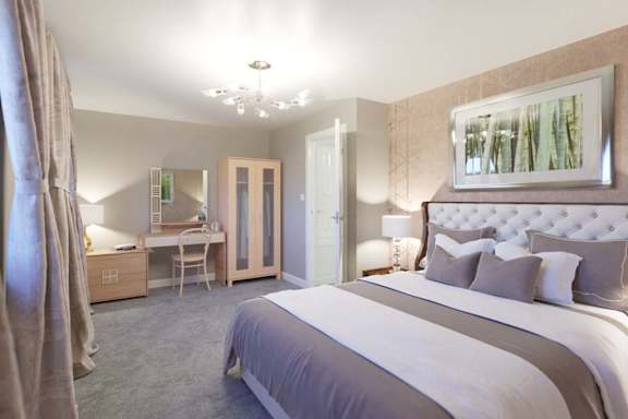 A bedroom with a large bed and a desk with a chair.