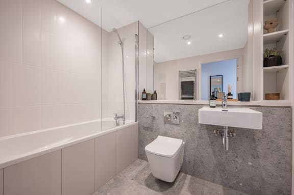 a bathroom with a toilet and a sink and a bath tub