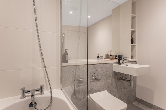a bathroom with a shower and a sink and a toilet