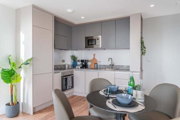a kitchen and dining area with a table and chairs