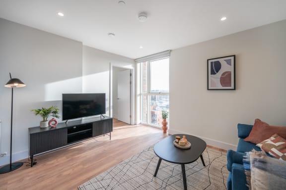 a living room with a couch and a table and a tv