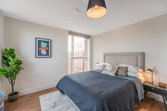 a bedroom with a large bed and a large window