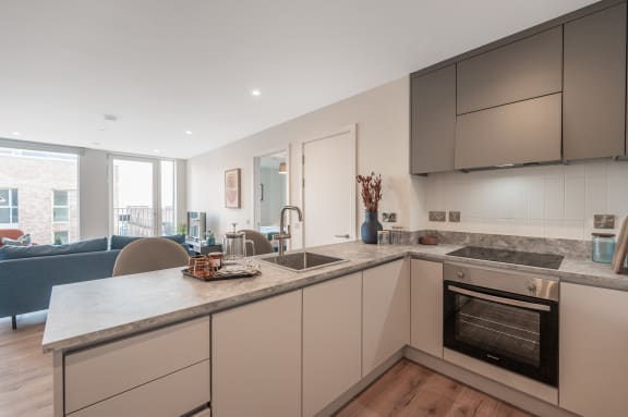 a kitchen with an island and a sink and a living room