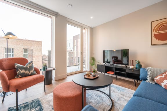 a living room with a couch and a coffee table and a television