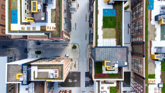 a bird s eye view of a city with buildings and grass