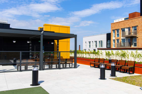 a terrace with tables and chairs outside of a building