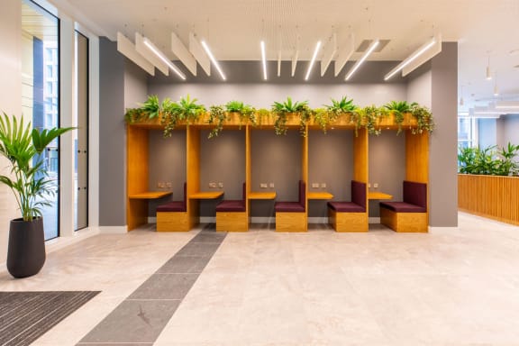 a large lobby with benches and plants