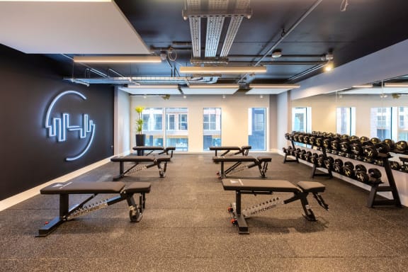 a large room filled with benches and yoga chars