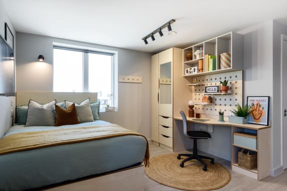 Floor Plan  a bedroom with a bed and a desk and a window