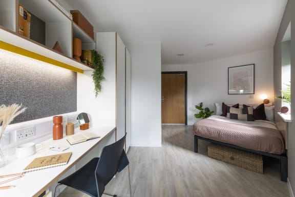 Floor Plan  a bedroom with a desk and a bed in a room