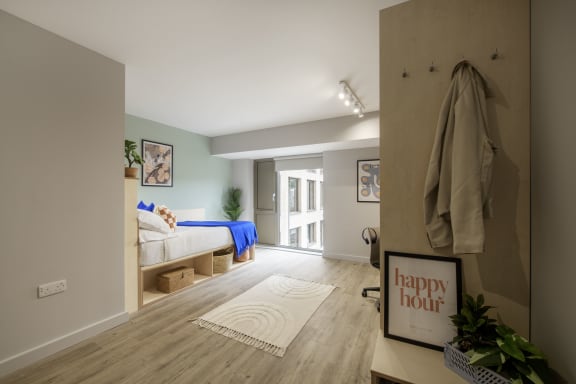 Floor Plan  a bedroom with a bed and a robe hanging on the wall