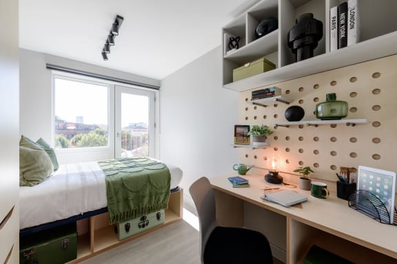 Floor Plan  a bedroom with a desk and a bed and a window
