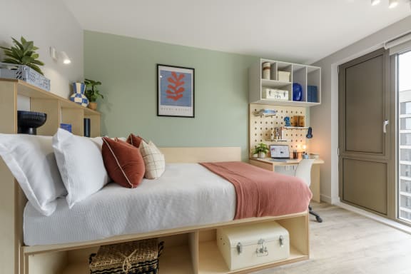 Floor Plan  a bedroom with a bed and a desk and a window