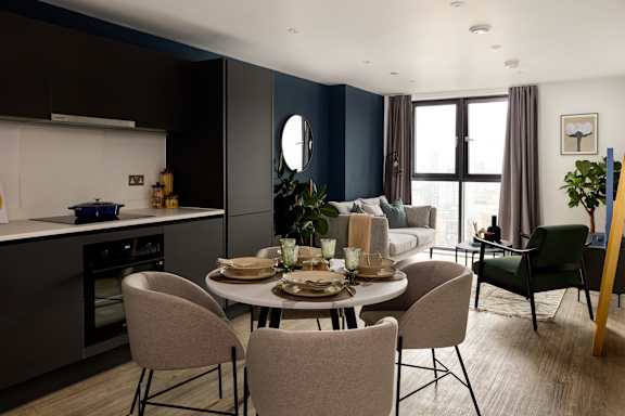 A modern dining room with a round table set for six.