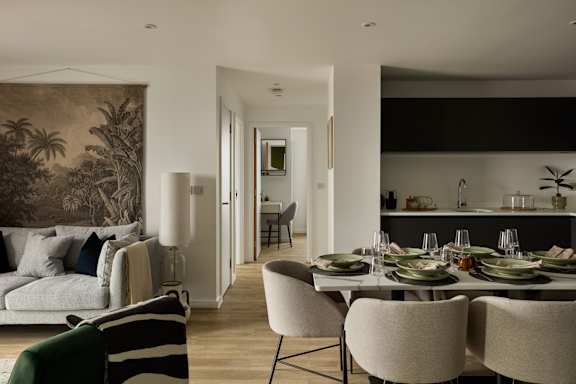 A dining room with a table set for a meal.