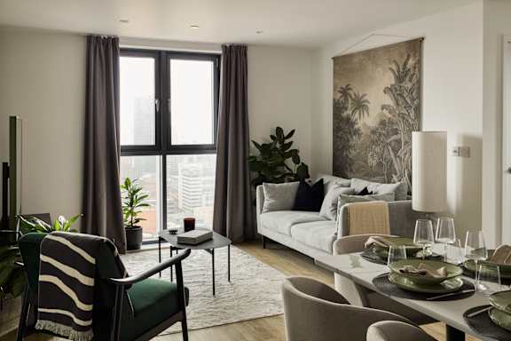 A modern living room with a large window and a couch.
