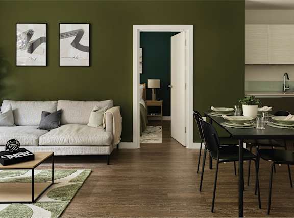 a living room and dining room with a table and chairs
