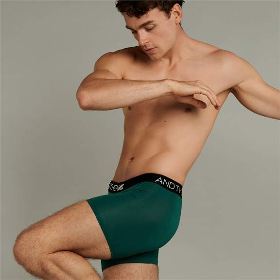 A man is wearing green underwear with the brand name ANDRO on the waistband.