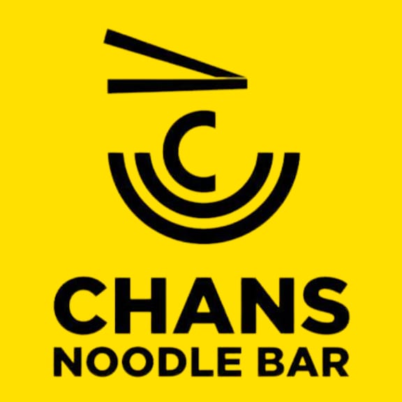 A yellow sign with a black logo and text that reads "Chans Noodle Bar".
