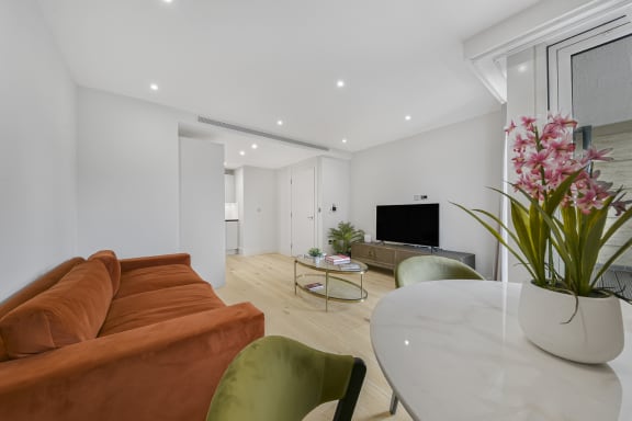 a living room with a couch and a table and a television