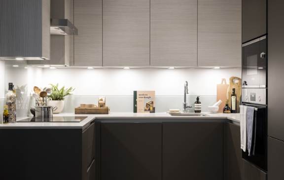 a kitchen with navy blue cabinets and a white counter top