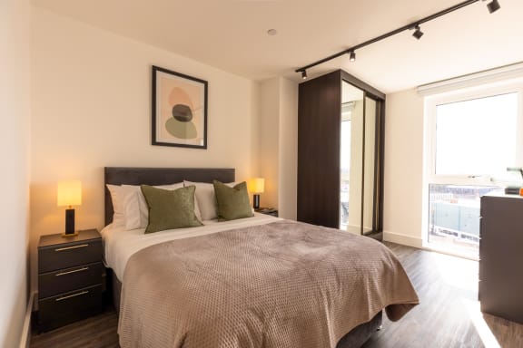 a bedroom with a large bed and a window