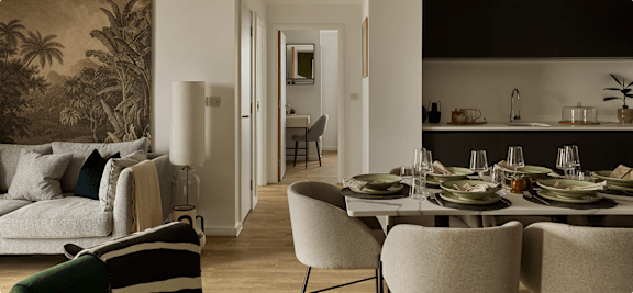 A dining room with a table set for a meal.