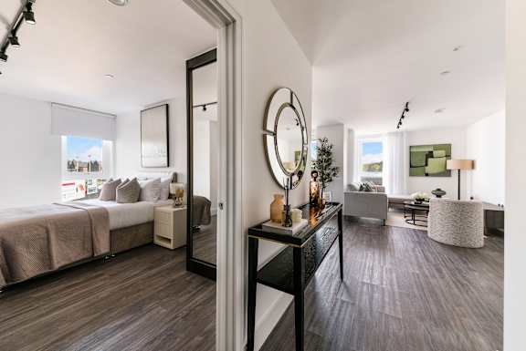 views of a bedroom and living room from a doorway