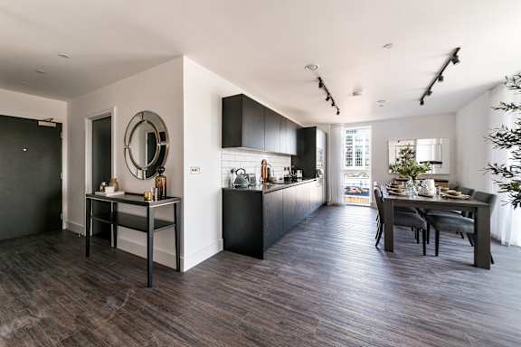 a kitchen and dining area with a table and chairs and a large window