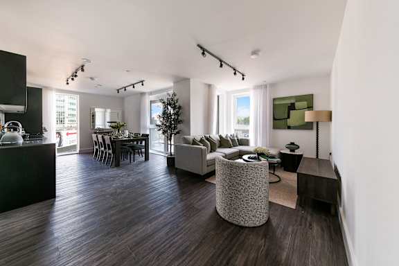 a living room and dining room in a modern apartment