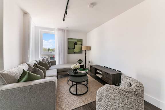 a living room with white walls and a large window