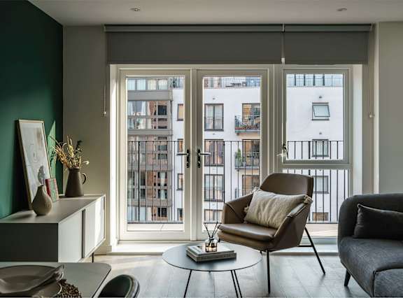 a living room and dining room with a table and chairs