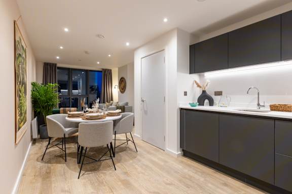 A modern dining room with a large table and chairs.
