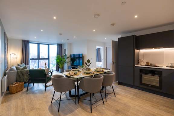 A modern dining room with a large table and chairs.