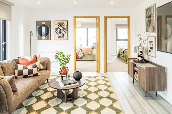 A living room with a couch, a coffee table, and a rug.