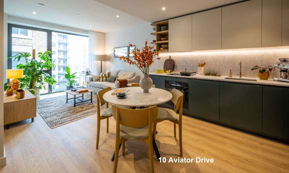A modern kitchen with a dining table set for two.