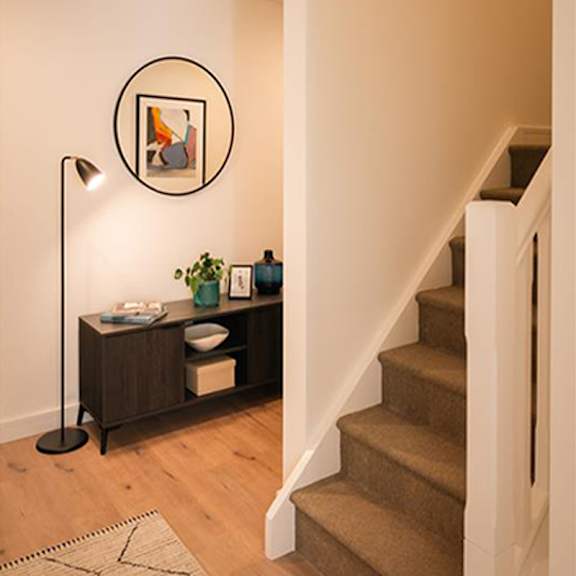A brown carpeted staircase with a white railing and a black floor lamp at Cherrywood Apartments, D18 VY3V, DUBLIN 18