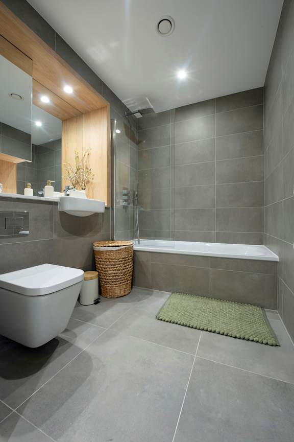 A modern bathroom with a white toilet and a white sink.