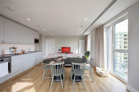 A modern kitchen with a dining table set for four.