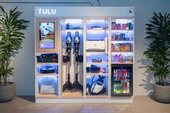 A Tulu vending machine with a variety of rentable items inside.