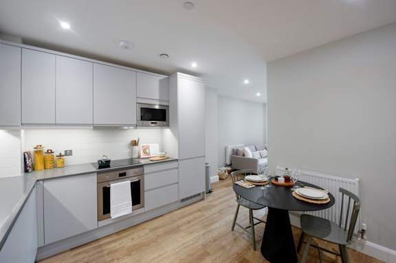 Floor Plan  A modern kitchen with a dining table set for two.