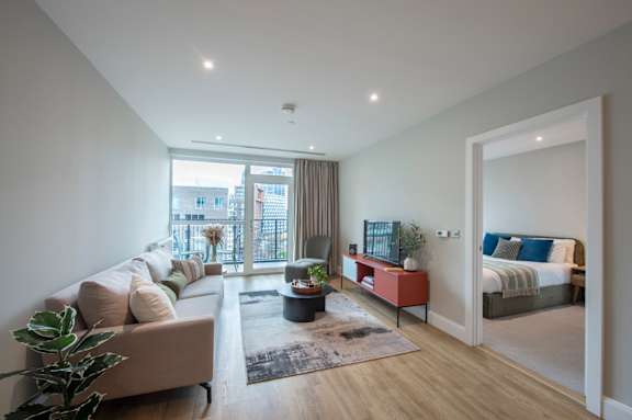A modern living room with a large window and a view of the city.