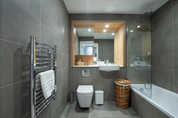 A bathroom with a toilet, sink, and a bathtub.