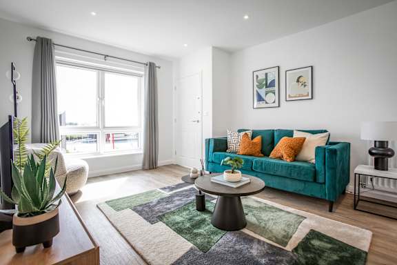 A living room with a green couch and a coffee table.